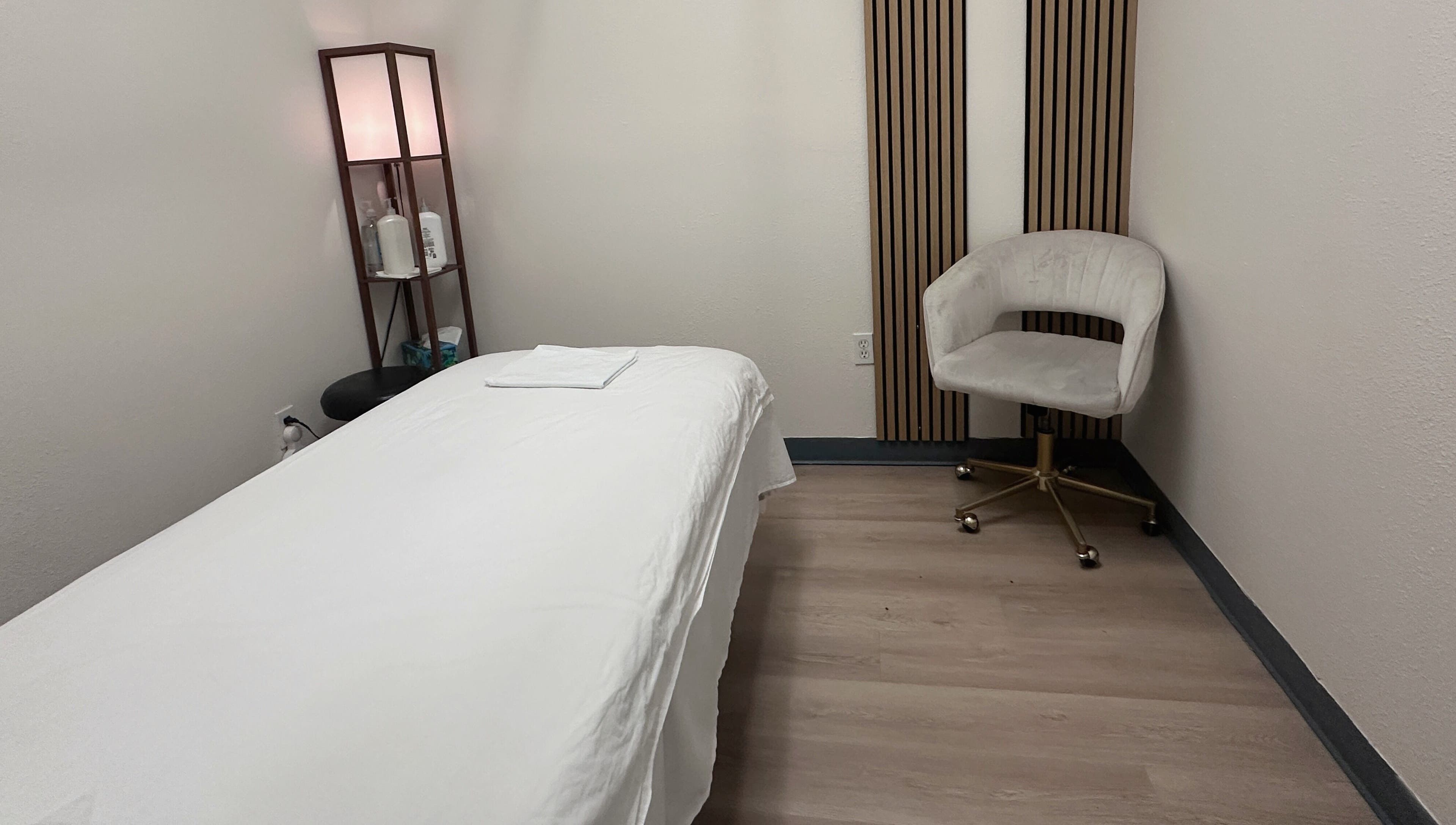 Tranquil treatment room at Elite Spa, Winter Springs, Florida, US, featuring a massage bed and elegant decor.