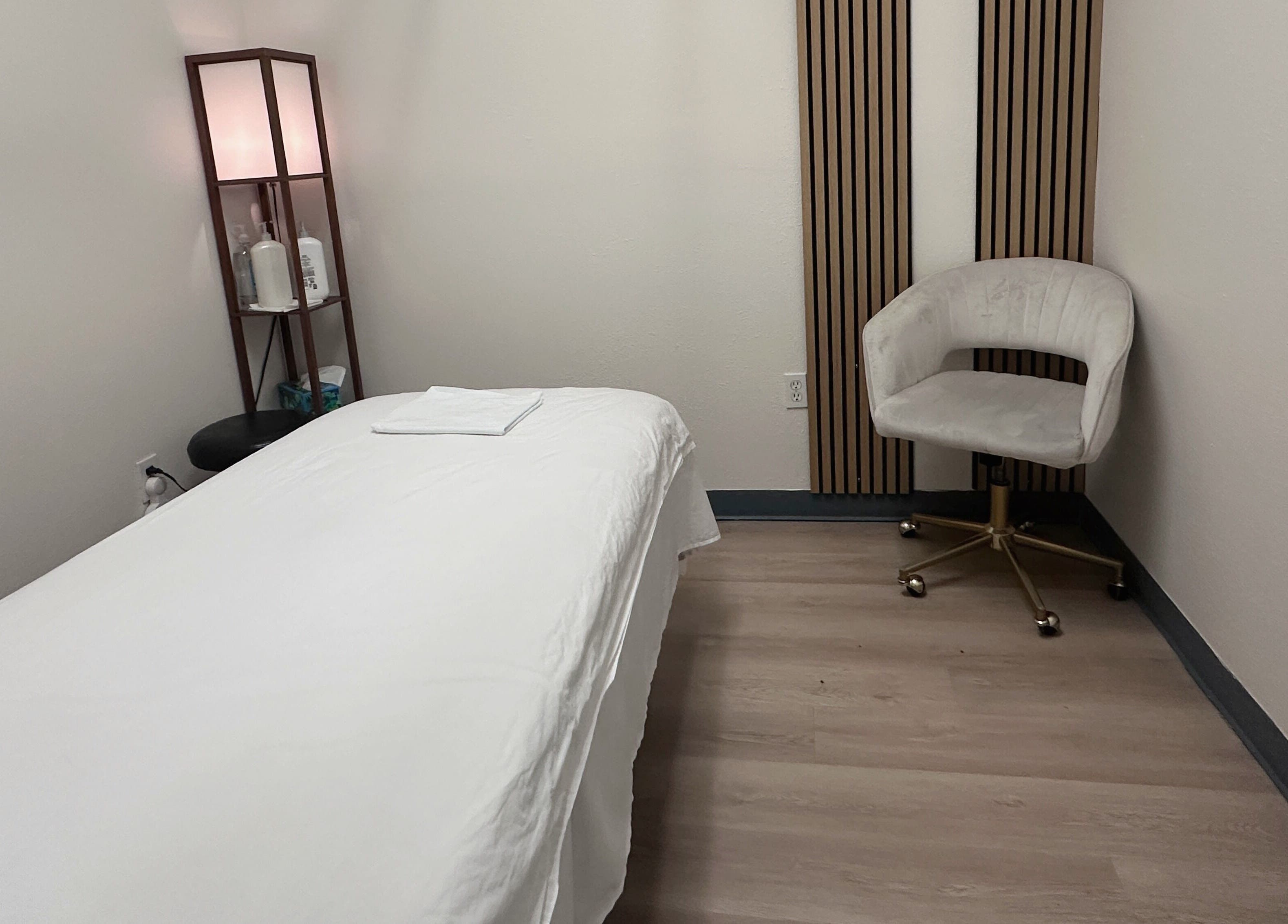 Tranquil treatment room at Elite Spa, Winter Springs, Florida, US, featuring a massage bed and elegant decor.