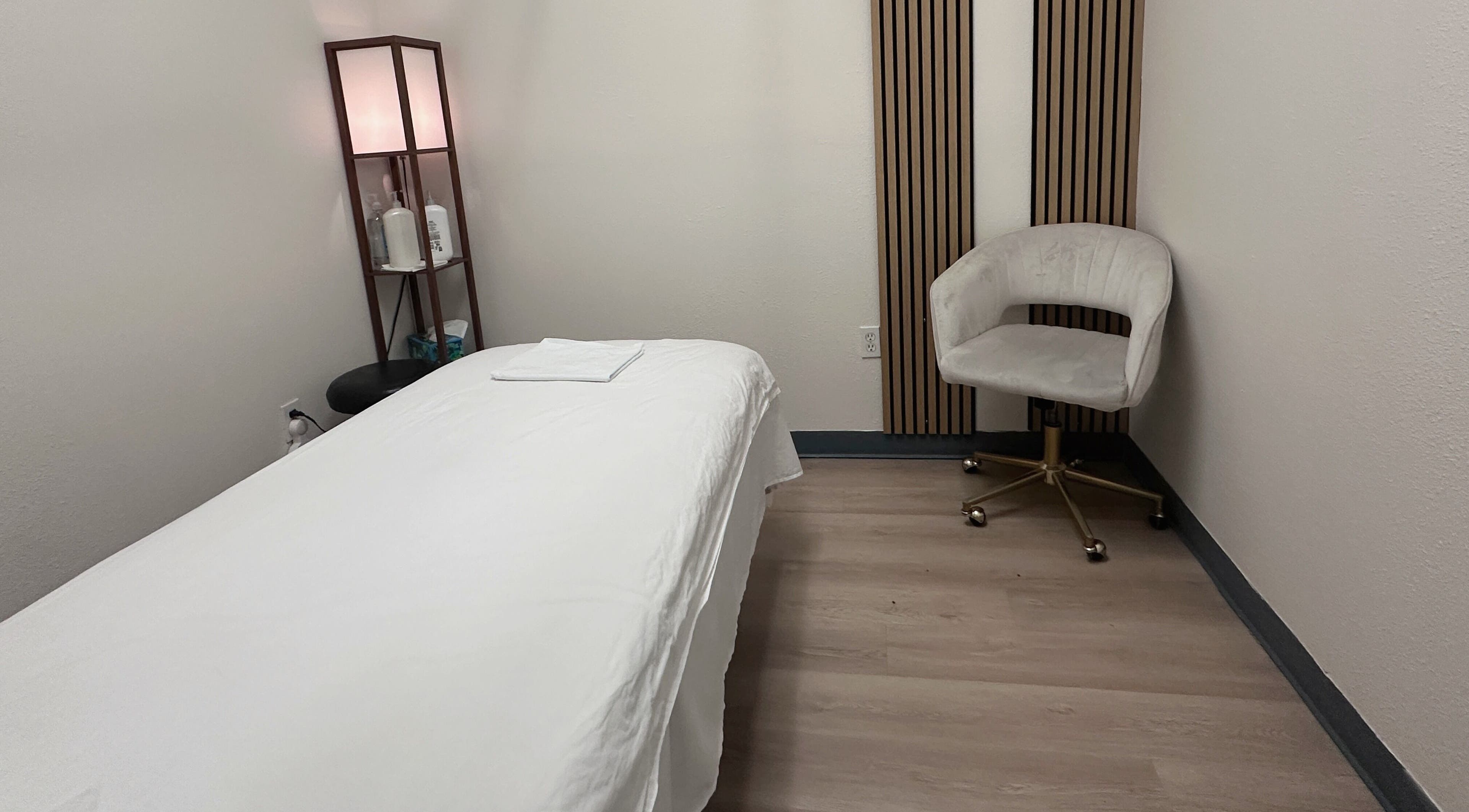 Tranquil treatment room at Elite Spa, Winter Springs, Florida, US, featuring a massage bed and elegant decor.