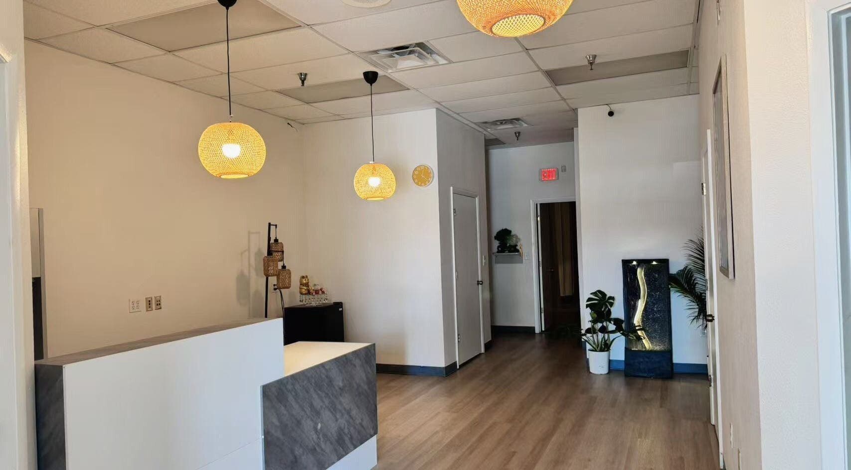 Warm, inviting lobby of Elite Spa in Winter Springs, Florida, US, with elegant lighting and modern decor.