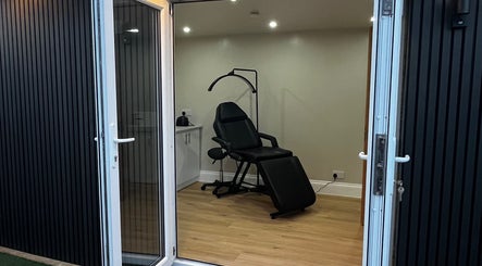 Stylish treatment room at Studio Twenty Seven, Clevedon, England, GB with a reclining chair and modern decor.