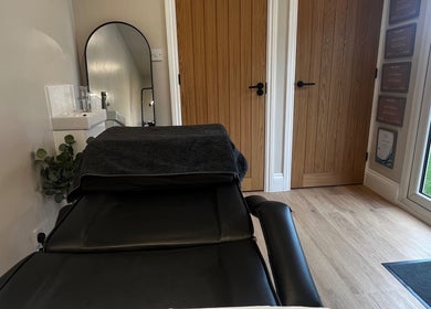 Cozy therapy room at Studio Twenty Seven, Clevedon, England, GB featuring a treatment bed and soothing decor.