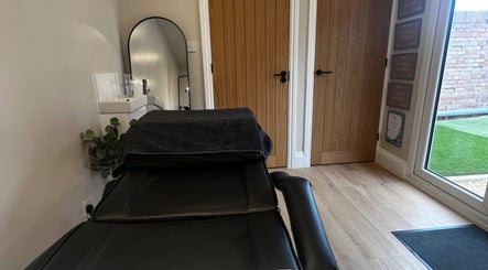 Cozy therapy room at Studio Twenty Seven, Clevedon, England, GB featuring a treatment bed and soothing decor.