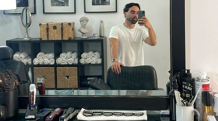 Sala de barbearia moderna no Terminal 4, Guimarães, PT, com espelho e ferramentas clássicas.