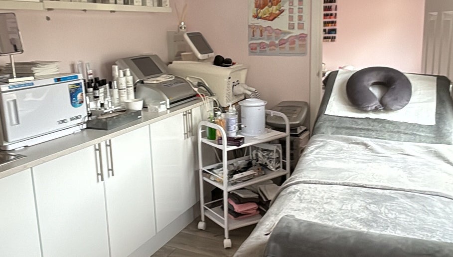 Relaxing treatment room at Bellissima, Borehamwood, England, GB with spa bed, equipment, and products.