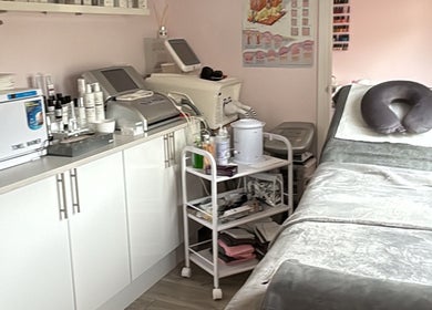 Relaxing treatment room at Bellissima, Borehamwood, England, GB with spa bed, equipment, and products.