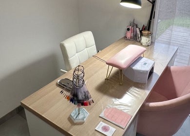 Espace manucure élégant chez La Pose Malleen, à Rivière-sur-tarn, Occitanie, FR, avec chaise rose et table en bois.