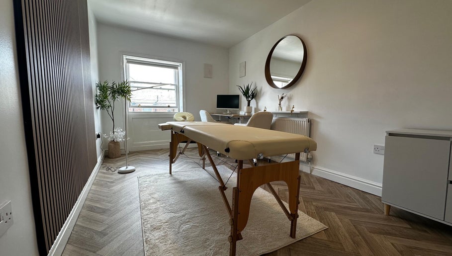 Peaceful therapy room at Nutritionally, Liverpool, England, GB with massage table and modern decor.