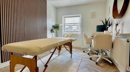 Elegant treatment room at Nutritionally, Liverpool, England, GB, featuring modern decor and massage table.