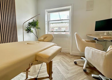A serene therapy room with massage table and plant at Nutritionally, Liverpool, England, GB.