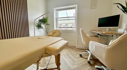A serene therapy room with massage table and plant at Nutritionally, Liverpool, England, GB.