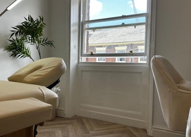 Relaxing massage room at Nutritionally, Liverpool, England, GB, featuring cozy chairs and soft lighting.