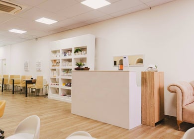 Elegant reception at Laleh Nail and Beauty in Cape Town, Western Cape, ZA with plush seating and product shelves.
