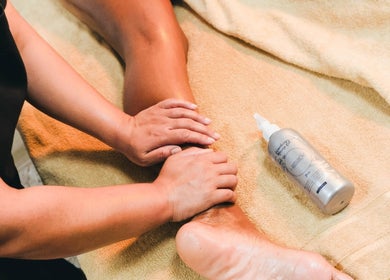 Relaxing leg massage at Laleh Nail and Beauty in Cape Town, Western Cape, ZA with nourishing oil on a spa towel.