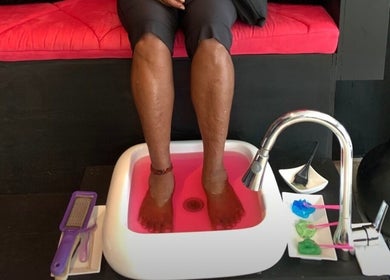 Feet soaking in pink water at Bre’s Beaute Bar, Diego Martin Regional Corporation, TT.