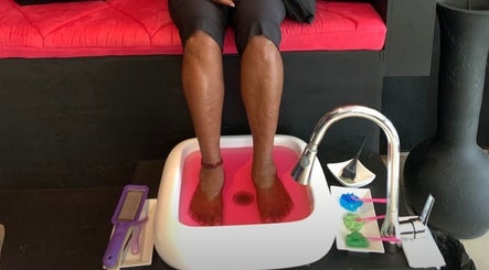 Feet soaking in pink water at Bre’s Beaute Bar, Diego Martin Regional Corporation, TT.