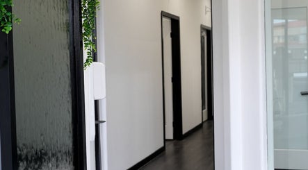 Calming hallway at The Skin Factory Inc, Abbotsford, British Columbia, CA, featuring a lush plant wall.