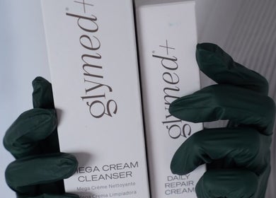 Gloved hands holding Gyuned products at The Skin Factory Inc, Abbotsford, British Columbia, CA.
