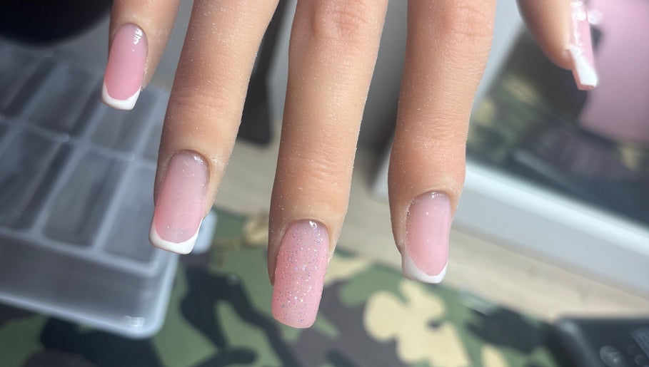 Elegant pink and white French manicure with glitter at NJK beauty, Shirebrook, England, GB.