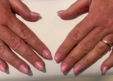 Pink glitter manicure at NJK beauty, Shirebrook, England, GB. Close-up of elegant nail art.
