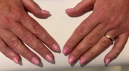 Pink glitter manicure at NJK beauty, Shirebrook, England, GB. Close-up of elegant nail art.