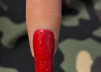Vibrant red nail art at NJK Beauty, Shirebrook, England, GB.