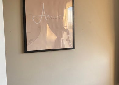 Framed Air Lashes and Brows logo on a sunlit wall in Ludlow, England, GB.