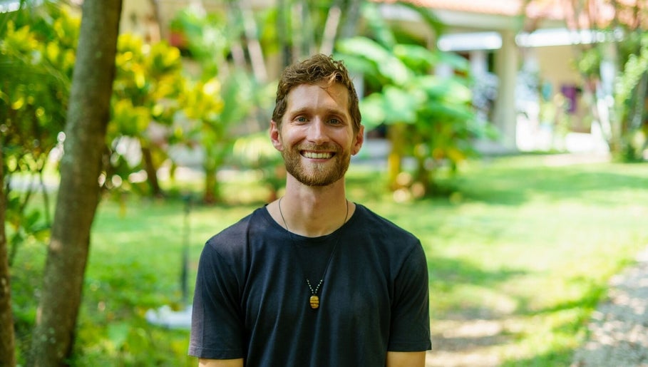 Smiling person in garden at Hikari Massage & Craniosacral, Boca Raton, Florida, US.