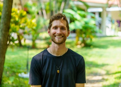 Smiling person in garden at Hikari Massage & Craniosacral, Boca Raton, Florida, US.