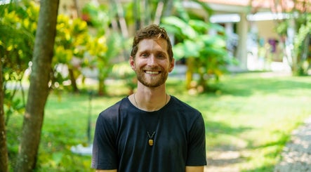 Smiling person in garden at Hikari Massage & Craniosacral, Boca Raton, Florida, US.