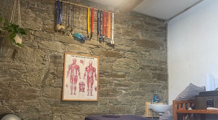 Massage room with stone walls at Marie’s Sports and Wellbeing Massage, Porthleven, England, GB.