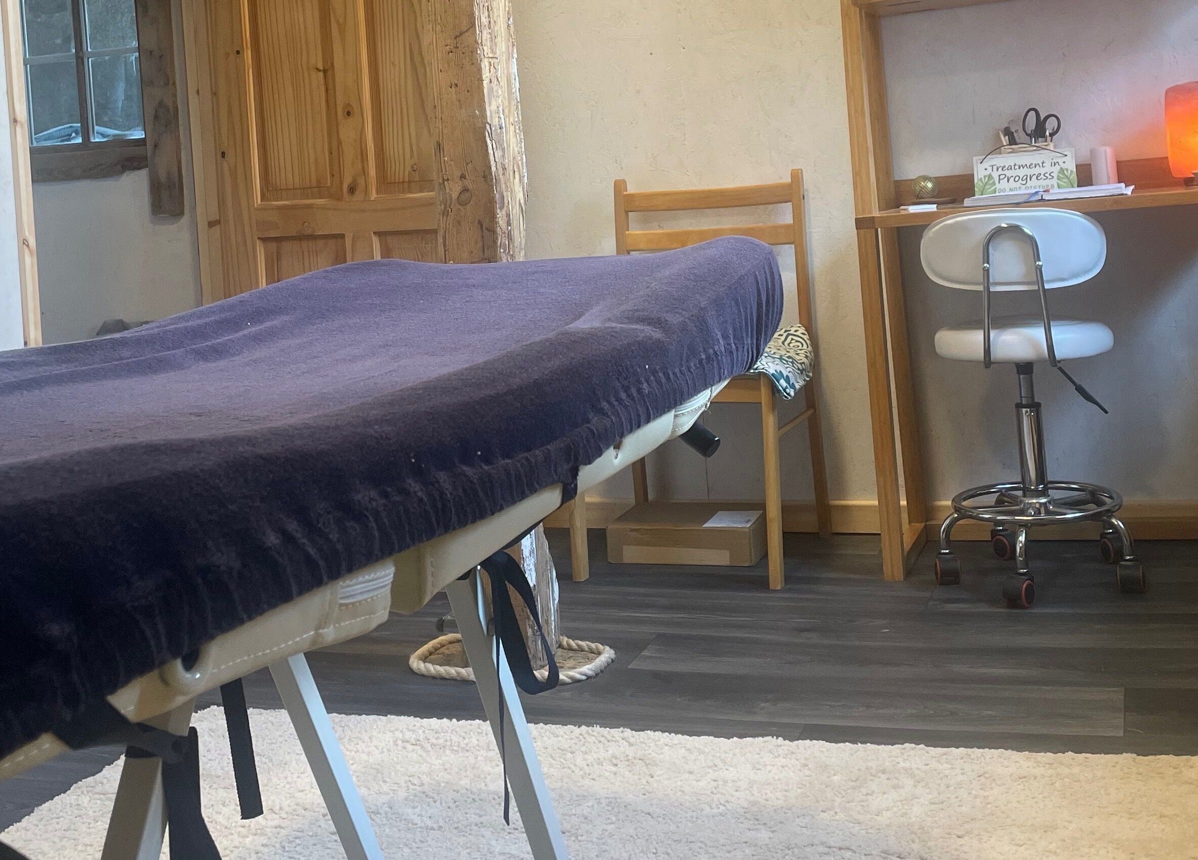 Tranquil massage room at Marie’s Sports and Wellbeing Massage in Porthleven, England, GB, with a massage table.