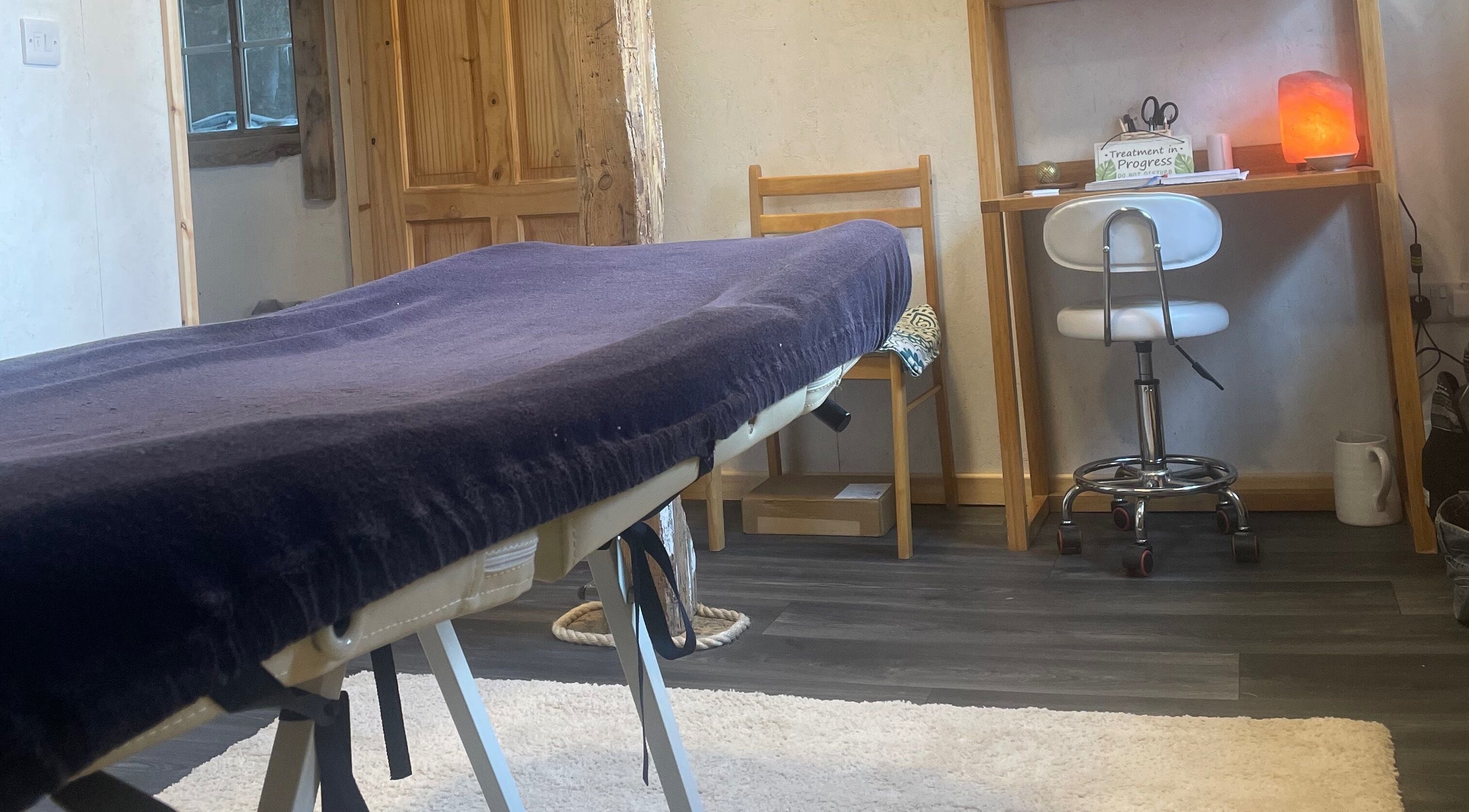 Tranquil massage room at Marie’s Sports and Wellbeing Massage in Porthleven, England, GB, with a massage table.