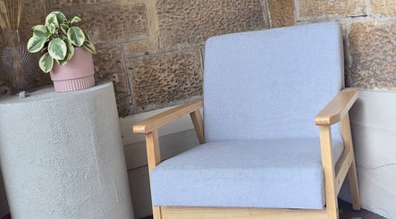Inviting seating area at Crystal Hair Adelaide, featuring a modern chair and plant in Parkside, South Australia, AU.