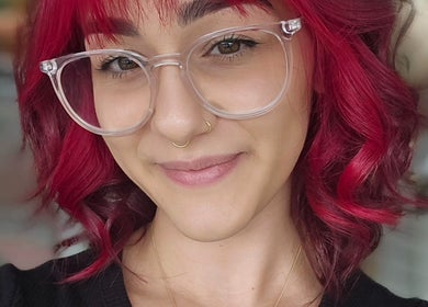 Smiling individual showcasing vibrant red hair styling at Crystal Hair Adelaide, Parkside, South Australia, AU.