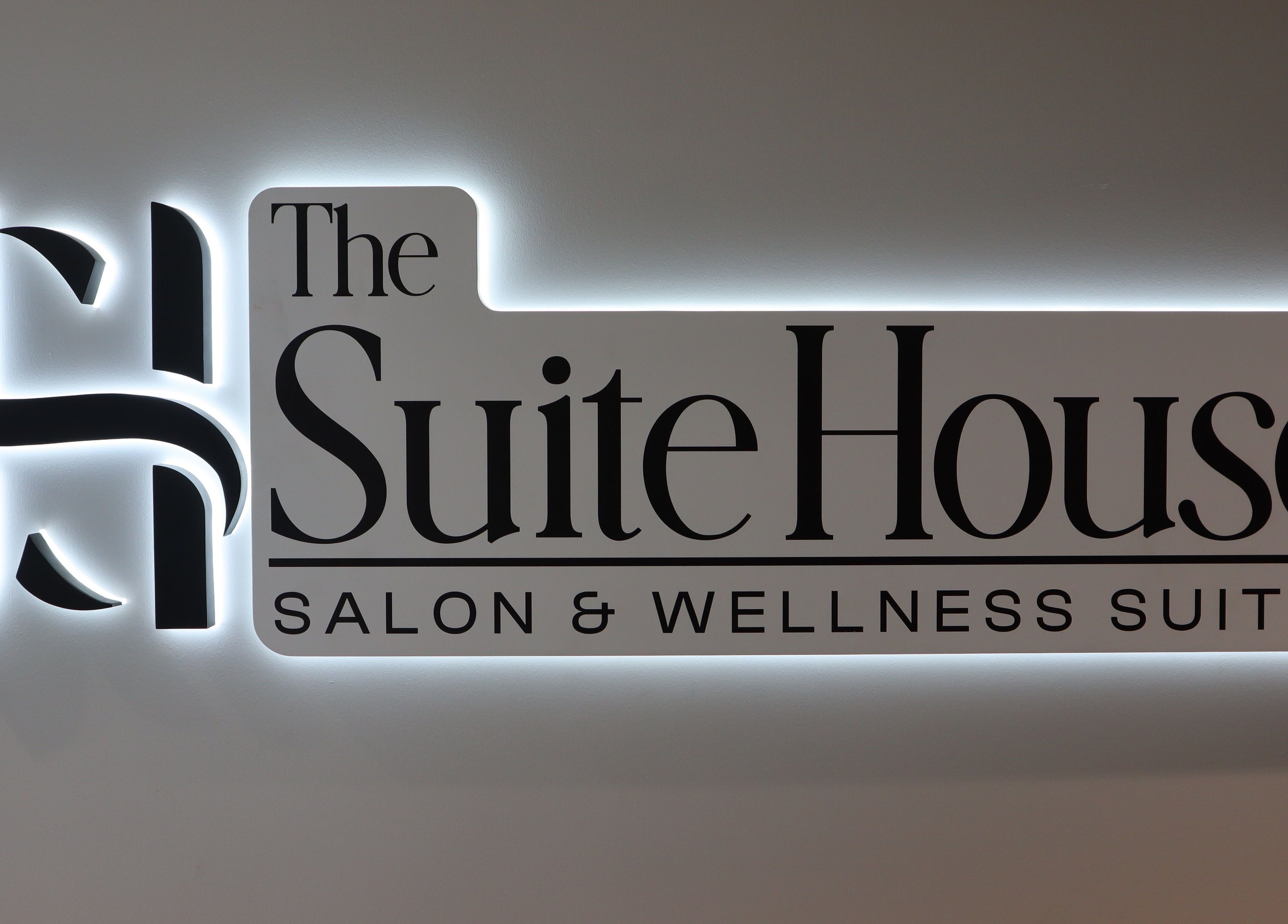 Illuminated sign of The Suite House at DIVINE DERMABAR, Toronto, Ontario, CA.