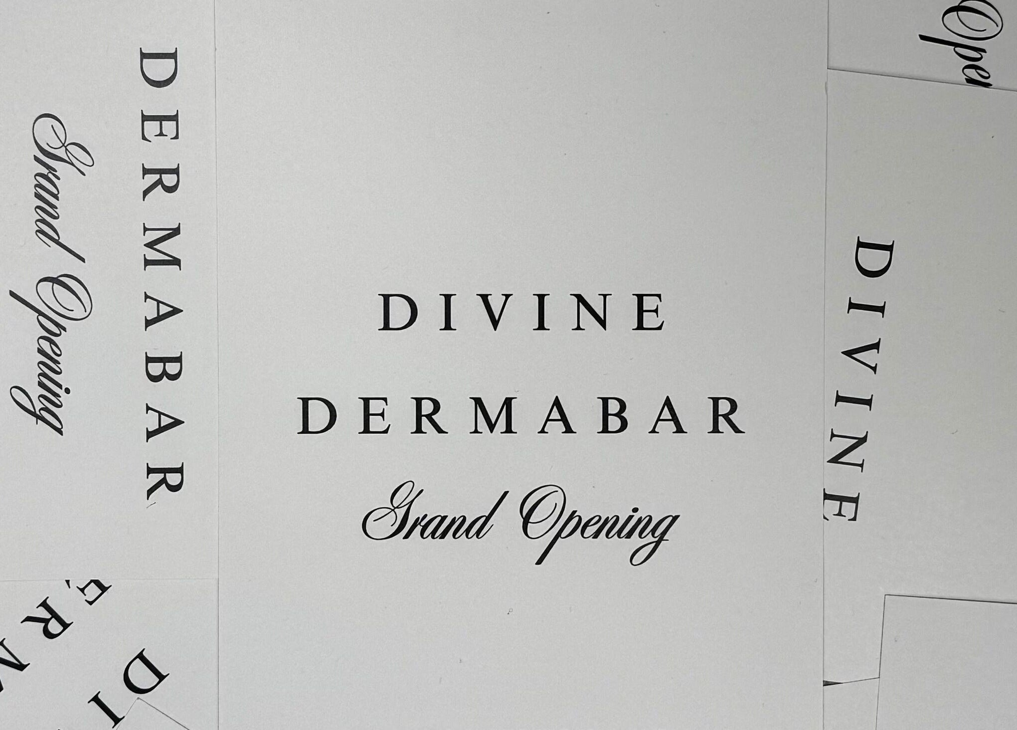 Divine Dermabar Grand Opening invitation card in Toronto, Ontario, CA, showcasing elegant typography.