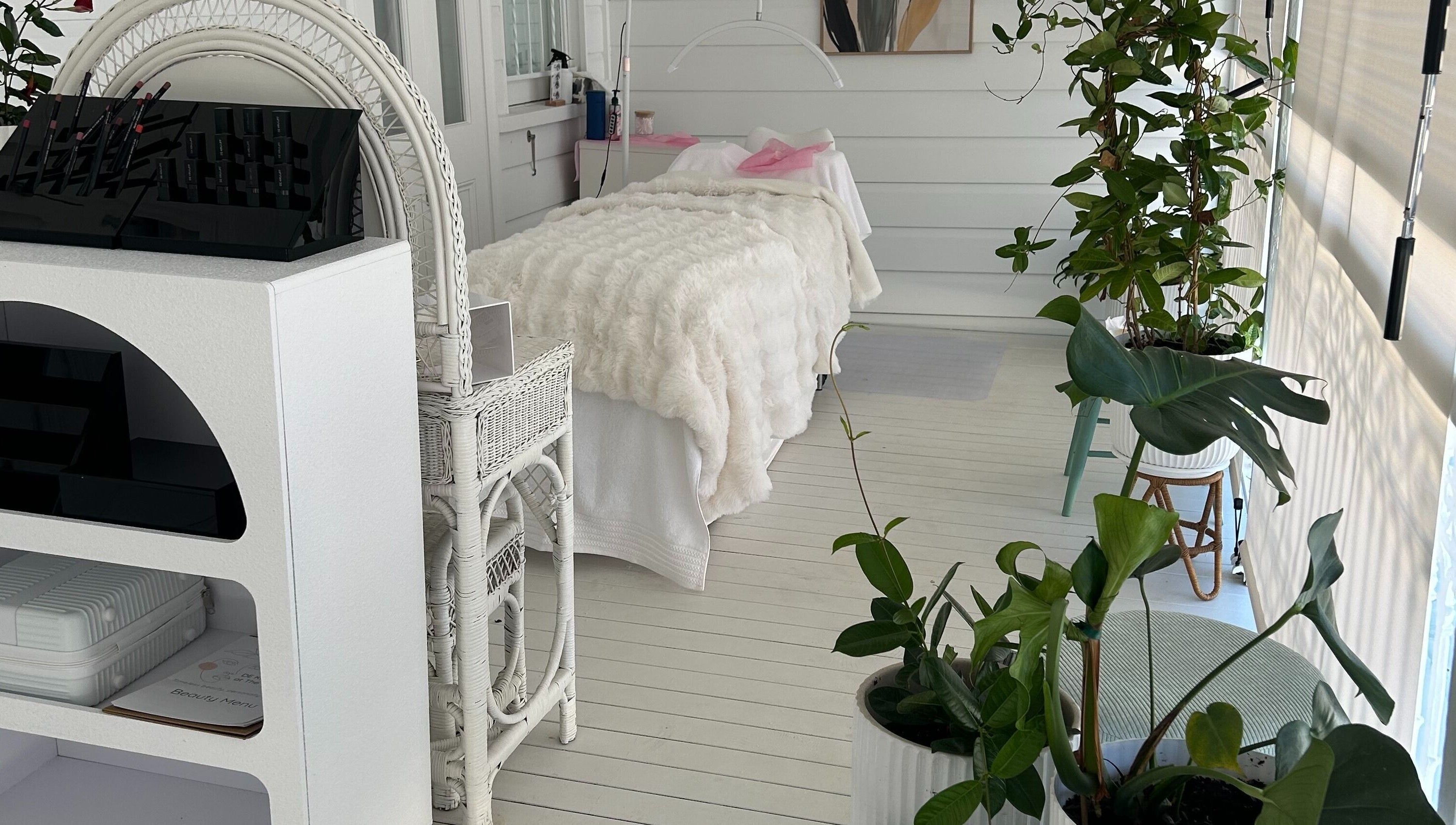 Calming white spa room at DE KRUIJFF at the Veranda, Highgate Hill, Queensland, AU with lush plants and elegant decor.