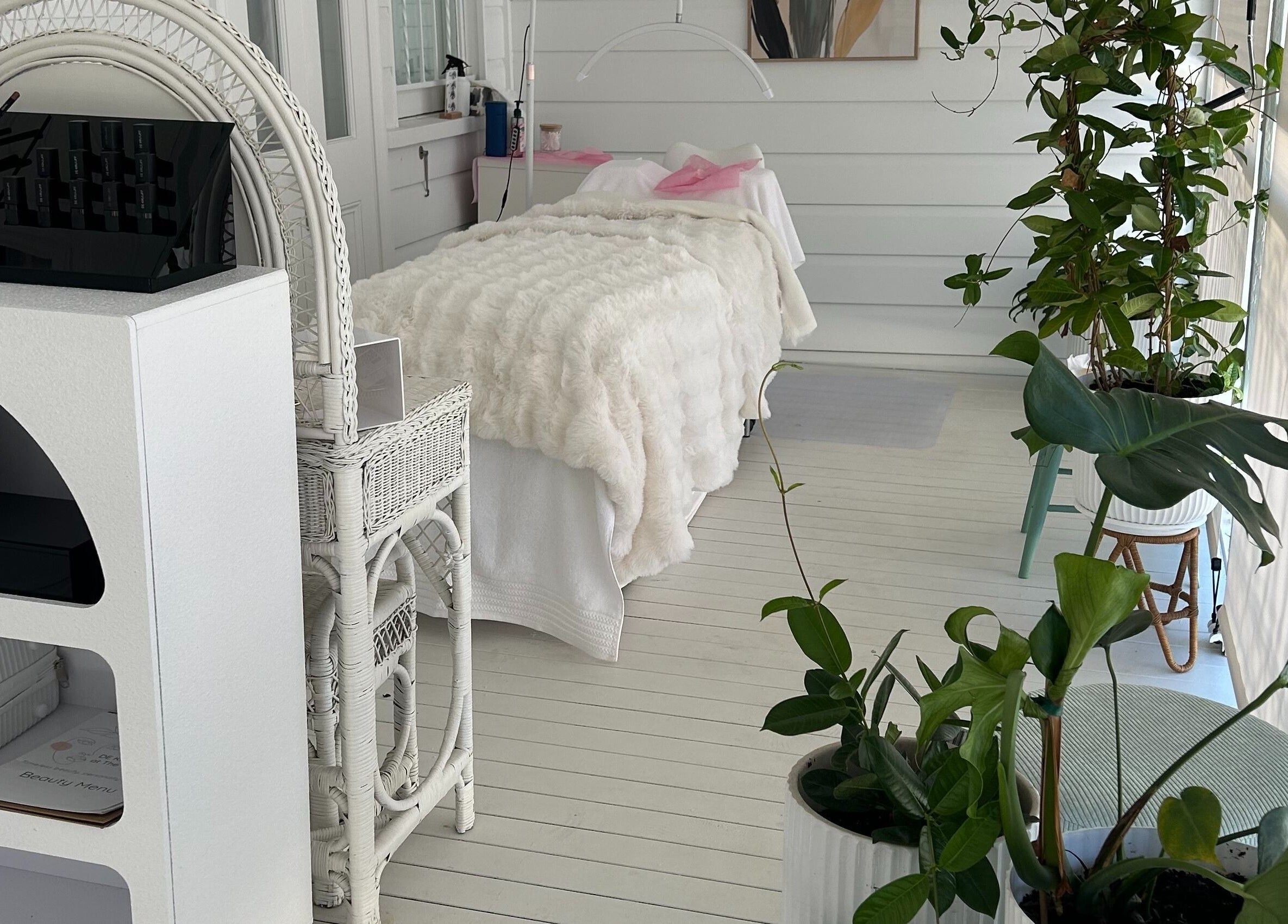 Calming white spa room at DE KRUIJFF at the Veranda, Highgate Hill, Queensland, AU with lush plants and elegant decor.
