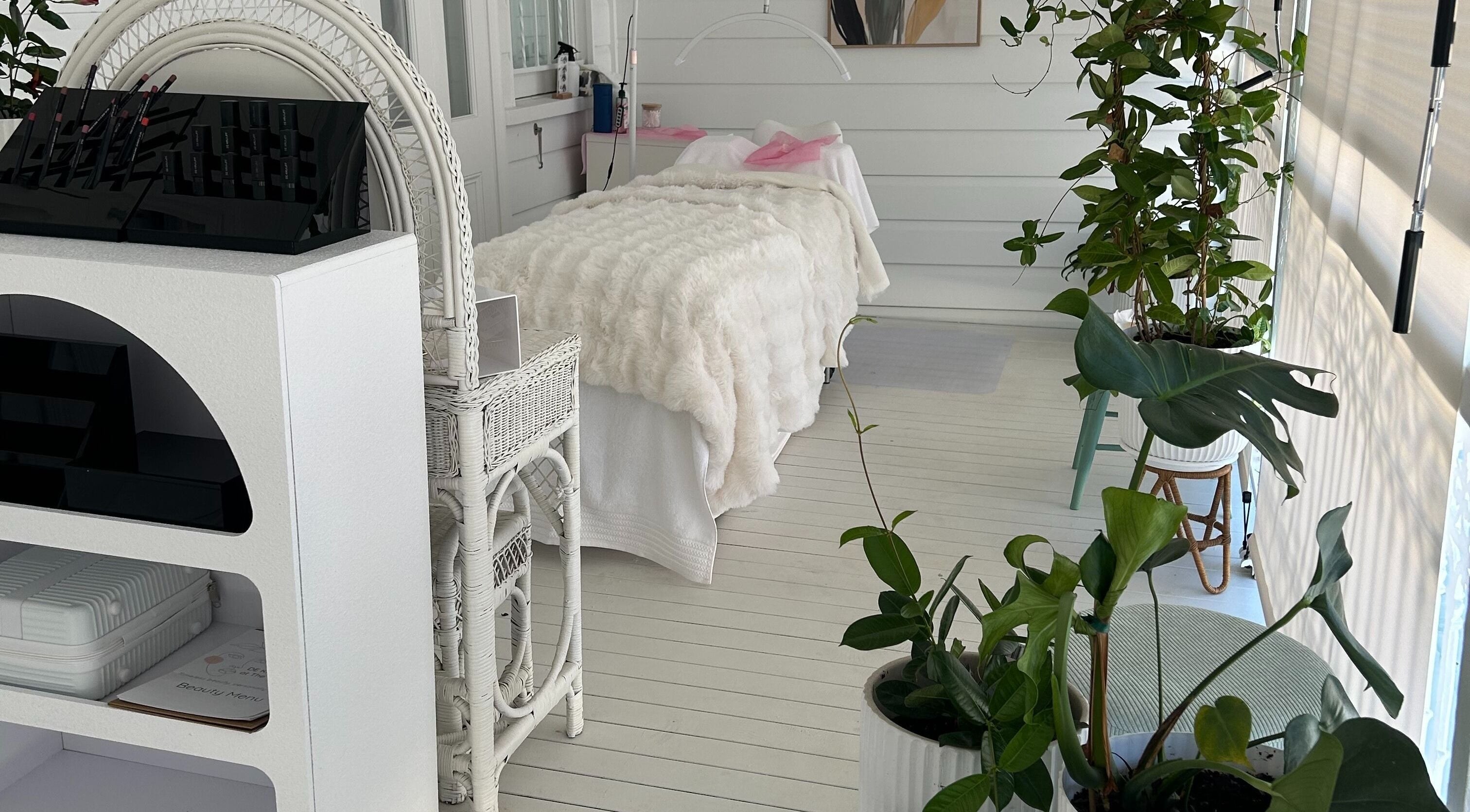 Calming white spa room at DE KRUIJFF at the Veranda, Highgate Hill, Queensland, AU with lush plants and elegant decor.