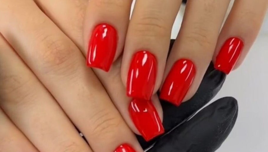 Elegant red manicure at Nail’s by yilm, Lakeland, Florida, US, showcasing expert nail artistry.