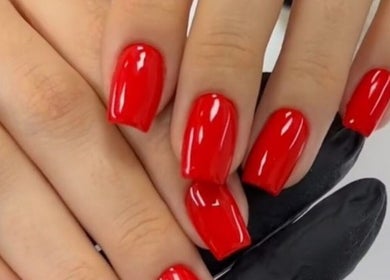Elegant red manicure at Nail’s by yilm, Lakeland, Florida, US, showcasing expert nail artistry.