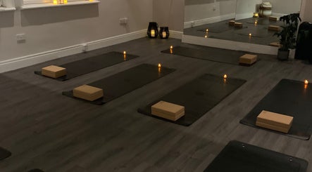 Candlelit yoga studio setup at Boston Spa Acupuncture and Yoga, Leeds, England, GB, with mats and props.