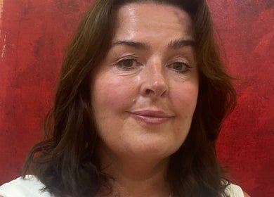 Welcoming staff member at Boston Spa Acupuncture and Yoga, Leeds, England, GB with vibrant red artwork.