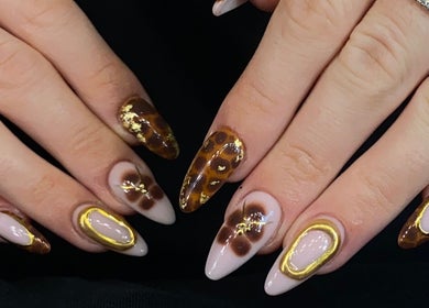 Elegant nail art with gold accents at Sugaplum Studio, Albion, Queensland, AU, showcasing intricate designs.