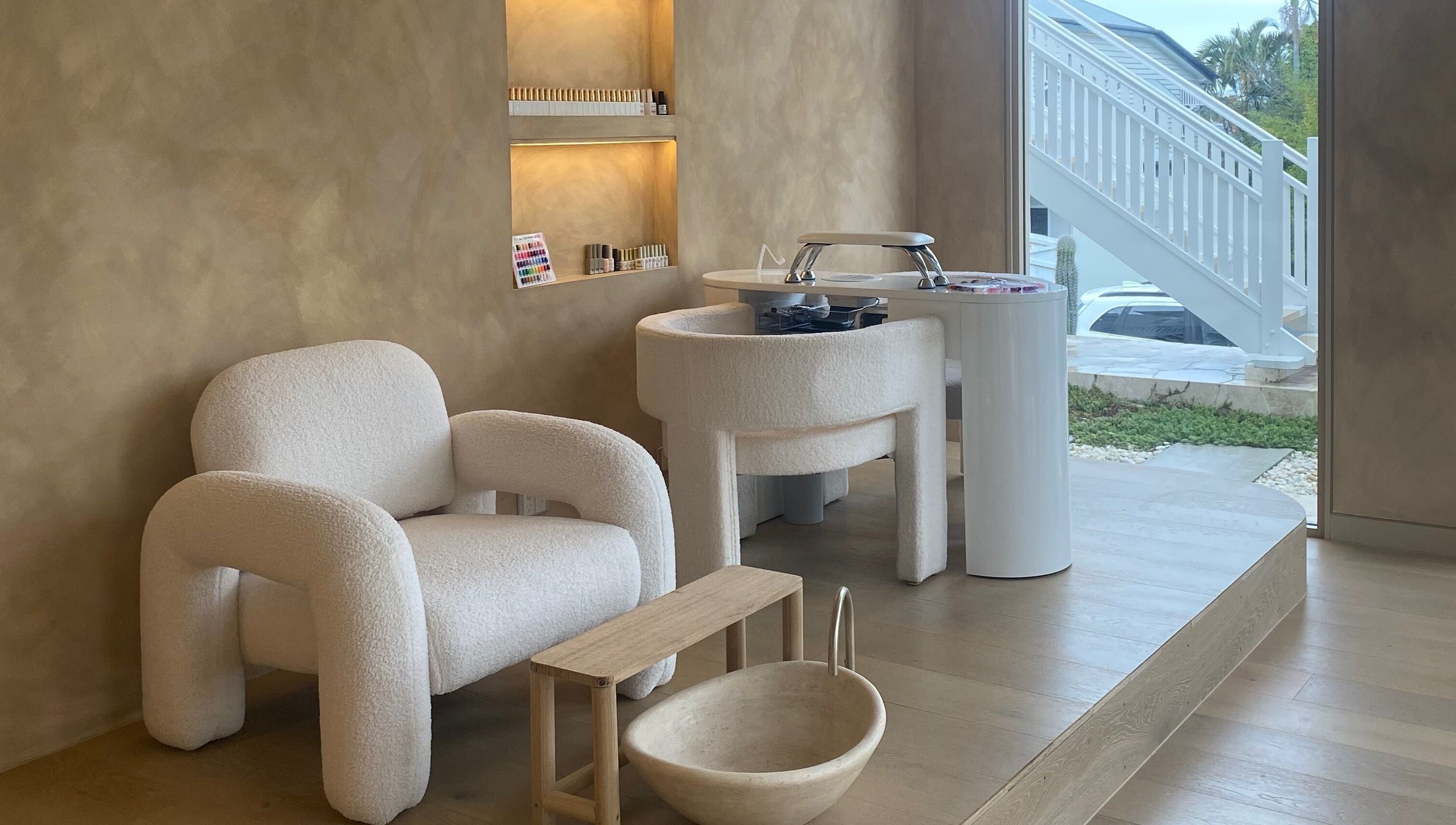 Chic beauty setup at Sugaplum Studio in Albion, Queensland, AU with plush seating and manicure station.