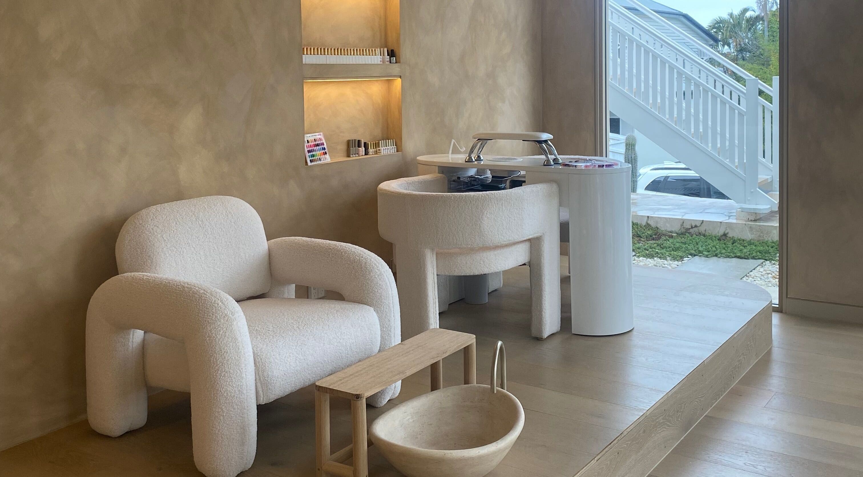 Chic beauty setup at Sugaplum Studio in Albion, Queensland, AU with plush seating and manicure station.