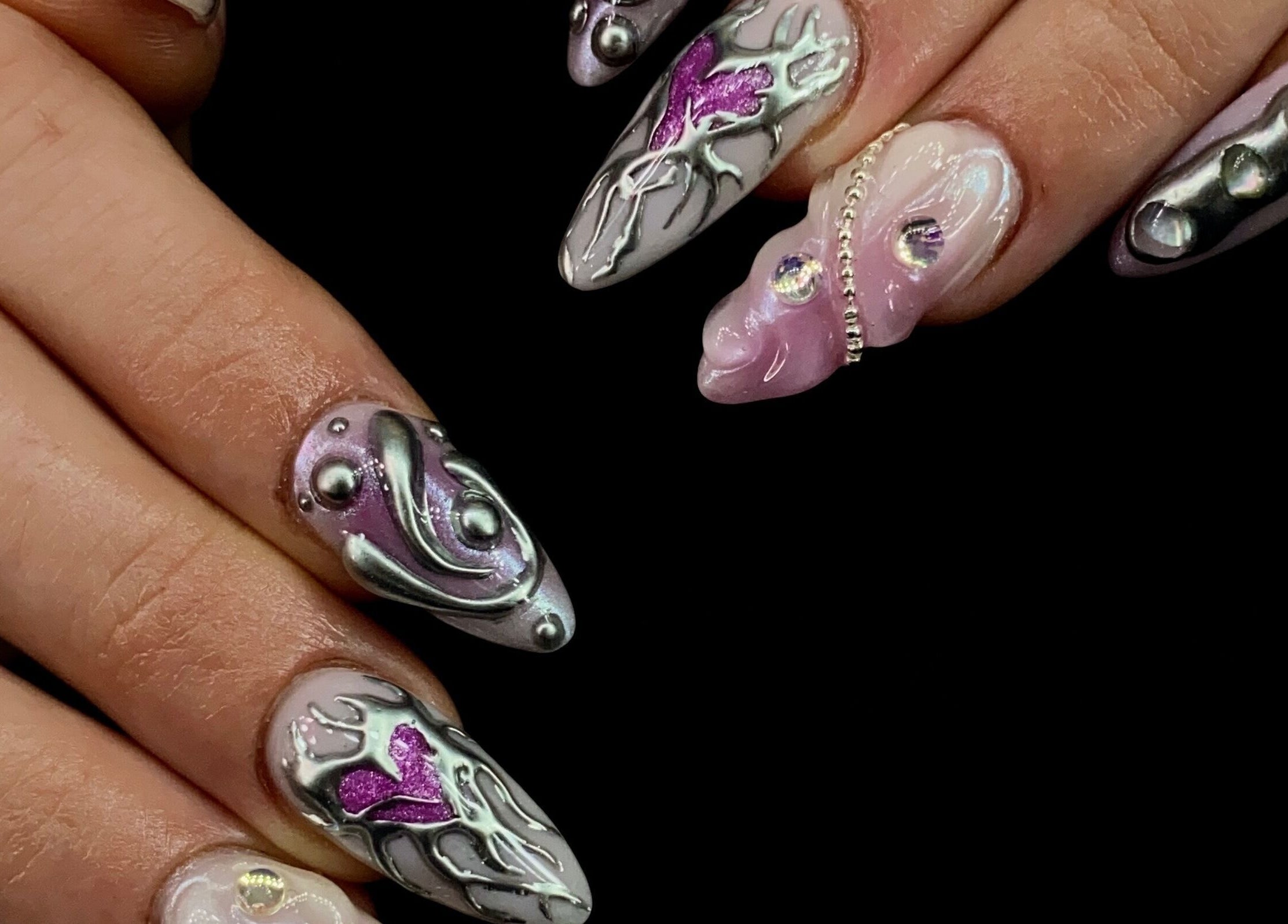 Intricate nail art with silver accents at Sugaplum Studio, Albion, Queensland, AU.