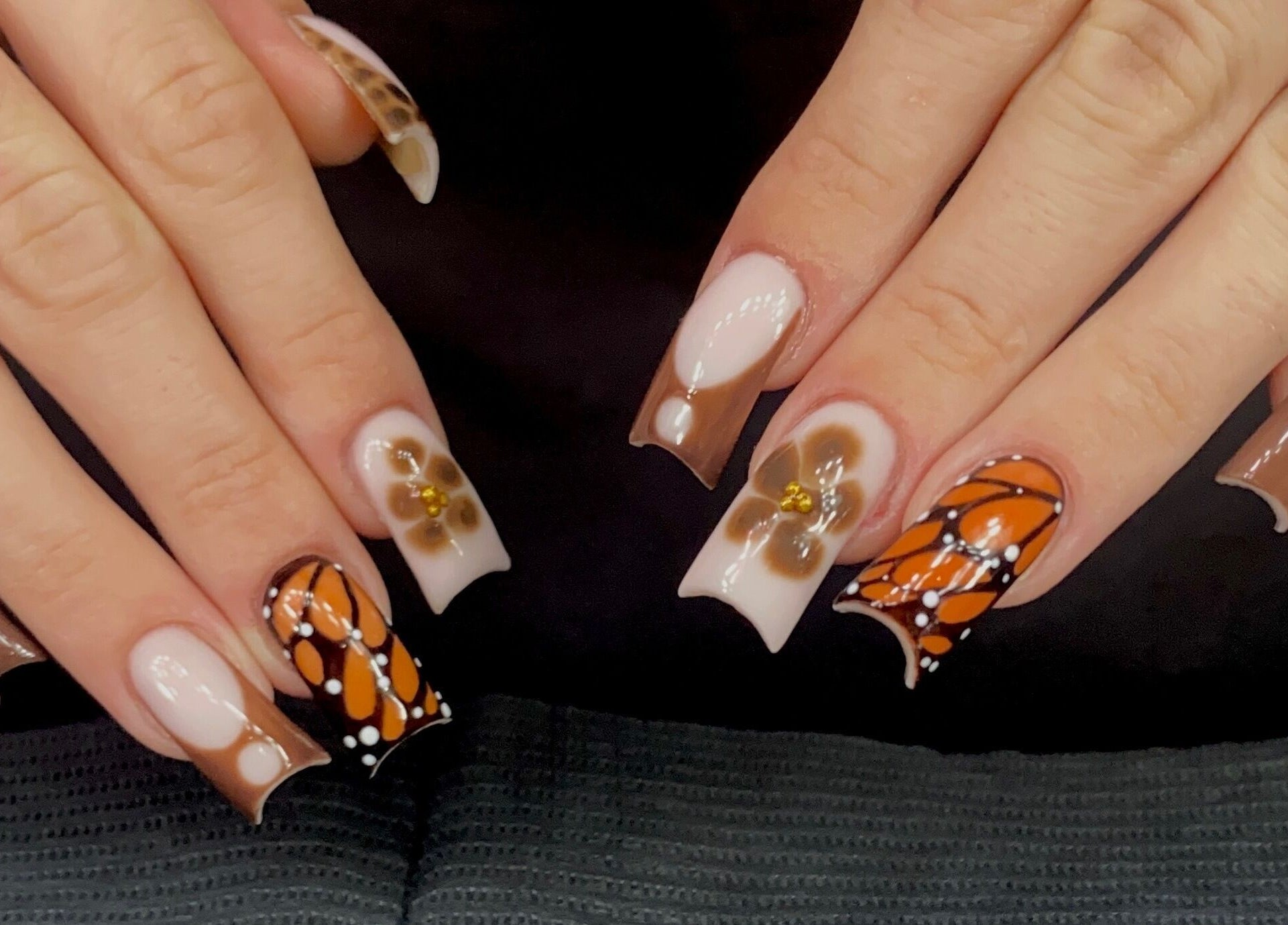 Creative nail art with brown floral and butterfly patterns at Sugaplum Studio, Albion, Queensland, AU.