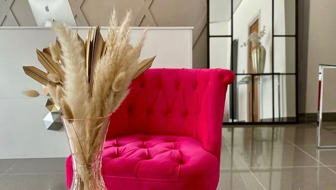 Vibrant pink chair in stylish decor at Rhianne Orla Skin, Broxburn, Scotland, GB.